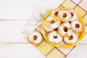Donuts served on yellow plate top view copy space. Sweet dessert pastry doughnuts.   Hanukkah sweet donuts. 