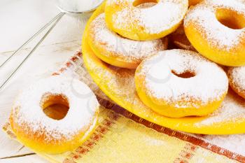 Donuts with caster sugar on checkered napkin. Hanukkah sweet donuts. Sweet dessert pastry doughnuts.  