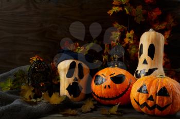 Halloween decorated pumpkins on dark rustic background, copy space. Halloween symbol jack-o-lantern background. Halloween decoration.