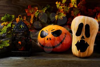 Halloween decorated pumpkins on dark rustic background. Halloween symbol jack-o-lantern background. Halloween decoration.