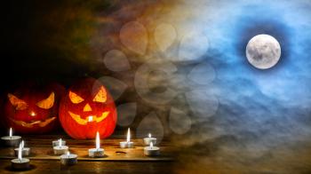 Halloween jack-o-lantern on the terrifying  midnight sky with full moon background. Halloween symbol smiling pumpkin background. 