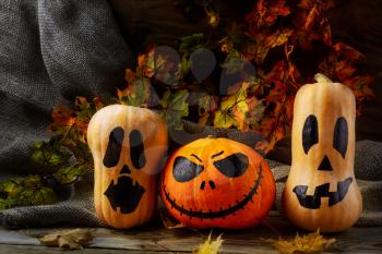 Halloween pumpkin heads on dark rustic background. Halloween symbol jack-o-lantern background. 