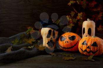 Halloween Stingy Jack pumpkins on rustic background, copy space. Halloween symbol jack-o-lantern background. Halloween decoration.