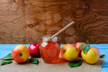 Healthy eating concept with glass honey jar and fresh apples, copy space. Jewesh new year symbols.