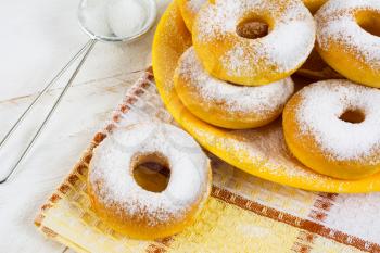 Homemade sweet donuts with caster sugar on checkered napkin. Hanukkah sweet donuts. Sweet dessert pastry doughnuts.  
