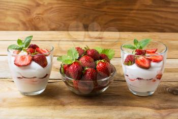 Layered diet dessert with yogurt, strawberry and ripe berries. Summer dessert with fresh strawberry.