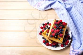 Soft Belgian waffles with blueberry, raspberry and blackcurrant copy space. Breakfast waffles with fresh berries.