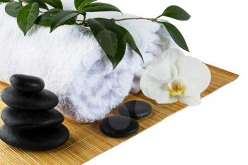 Spa concept with white orchid and spa stones isolated on white. Wellness spa treatment concept. 
