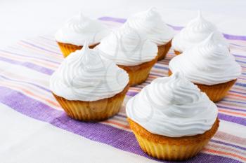 Sweet cupcakes with white whipped cream . Homemade cupcakes with whipped cream.  Sweet gourmet pastry dessert. Homemade cupcakes served for party. 