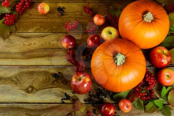 Thanksgiving background with pumpkins, berries and apples. Thanksgiving party invitation card.