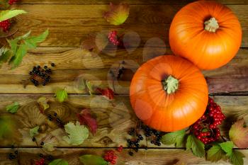 Thanksgiving concept  with pumpkins, berries and apples. Autumn background with seasonal vegetables and fruits.