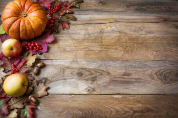 Thanksgiving or fall greeting with pumpkins and fall leaves on blue background. Fall background. Thanksgiving background with seasonal vegetables and fruits. Copy space