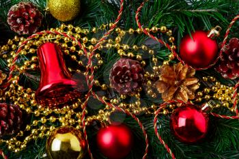 Christmas background with golden pinecone and red ornaments. Christmas party decoration with shiny balls. Christmas greeting background.