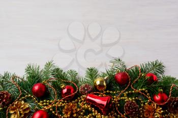 Christmas background with pinecone, golden and red ornaments. Christmas party decoration with shiny balls. Christmas greeting background. Copy space.