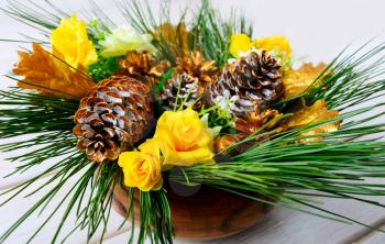 Christmas dinner table centerpiece with golden cones. Christmas decoration with golden decor. Christmas party background.