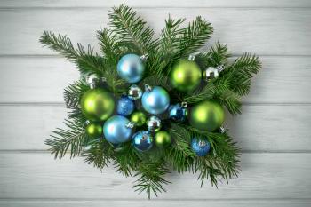 Christmas table centerpiece with blue and green ornaments, toned. Christmas party decoration with shiny balls. Christmas greeting background.