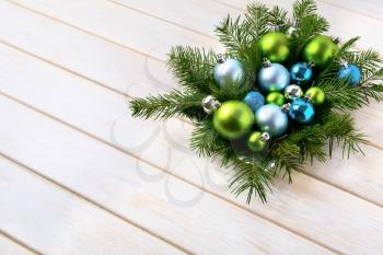 Christmas dinner table centerpiece with navy blue and green ornaments. Christmas party decoration with shiny balls. Christmas greeting background. Copy space. 