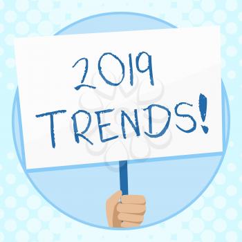 Conceptual hand writing showing 2019 Trends. Concept meaning general direction in which something is developing or changing Hand Holding Placard Supported by Handle Social Awareness