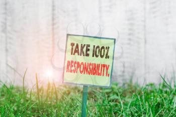 Conceptual hand writing showing Take 100 Percent Responsibility. Concept meaning be fully accountable for your Actions and Thoughts Plain paper attached to stick and placed in the grassy land