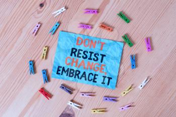 Word writing text Don T Resist Change Embrace It. Business photo showcasing Be open to changes try new things positive Colored clothespin papers empty reminder wooden floor background office