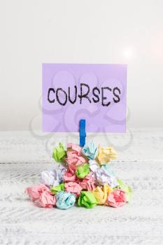 Word writing text Courses. Business photo showcasing Route Direction followed Classes Land Water Area for sports Reminder pile colored crumpled paper clothespin reminder white wooden space