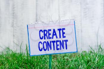 Word writing text Create Content. Business photo showcasing something that is to be expressed through some medium Mathematic paper attached to a stick and placed in the green grassy land