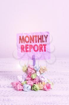 Writing note showing Monthly Report. Business concept for An assessment that takes place during a project or process, Reminder pile colored crumpled paper clothespin wooden space