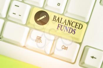 Word writing text Balanced Funds. Business photo showcasing hybrid mutual fund that combines different securities