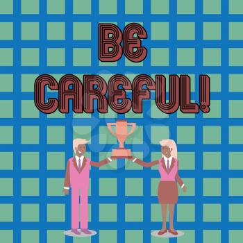 Text sign showing Be Careful. Business photo text making sure of avoiding potential danger mishap or harm Man and Woman in Business Suit Holding Together the Championship Trophy Cup