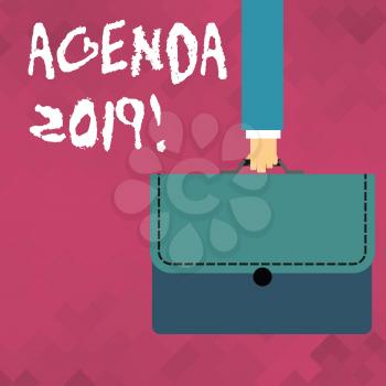 Word writing text Agenda 2019. Business photo showcasing list of items to be discussed at formal meeting or event Businessman Hand Carrying Colorful Briefcase Portfolio with Stitch Applique