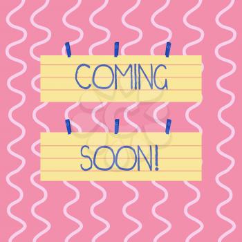 Text sign showing Coming Soon. Business photo showcasing event or action that will happen after really short time Two Color Blank Strip Size Lined Paper Sheet Hanging Using Blue Clothespin
