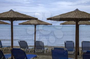 Crystal clear beach blue water view in a resort, good sitting spot undershades native umbrella from sun. Relaxing and comforting scenery of the ocean.