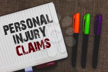 Text sign showing Personal Injury Claims. Conceptual photo being hurt or injured inside work environment Open notebook page jute background colorful markers Expressing ideas
