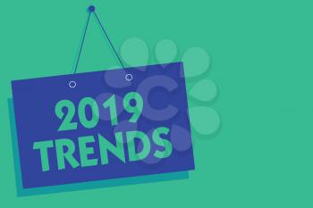 Writing note showing 2019 Trends. Business photo showcasing things that is famous for short period of time in current year Blue board wall message communication open close sign green background