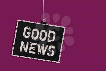 Word writing text Good News. Business concept for Someone or something positive,encouraging,uplifting,or desirable Hanging blackboard message communication information sign purple background