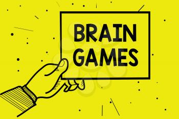 Word writing text Brain Games. Business concept for psychological tactic to manipulate or intimidate with opponent Man hand holding paper communicating information dotted yellow background