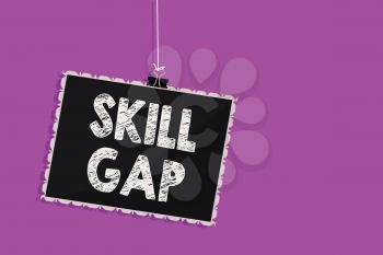 Text sign showing Skill Gap. Conceptual photo Refering to a person's weakness or limitation of knowlege Hanging blackboard message communication information sign purple background