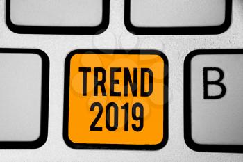 Text sign showing Trend 2019. Conceptual photo things that is famous for short period of time in current year Keyboard orange key Intention create computer computing reflection document