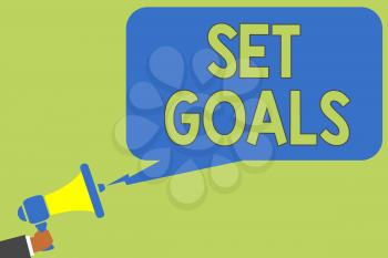 Text sign showing Set Goals. Conceptual photo Defining or achieving something in the future based on plan Man holding megaphone loudspeaker speech bubble message speaking loud