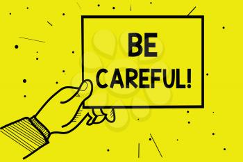 Word writing text Be Careful. Business concept for making sure of avoiding potential danger mishap or harm Man hand holding paper communicating information dotted yellow background