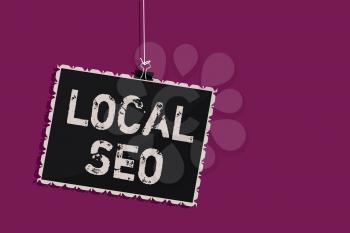 Word writing text Local Seo. Business concept for This is an effective way of marketing your business online Hanging blackboard message communication information sign purple background