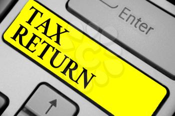 Writing note showing Tax Return. Business photo showcasing which taxpayer makes annual statement of income circumstances Keyboard yellow key Intention computer computing reflection document
