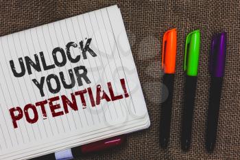 Text sign showing Unlock Your Potential. Conceptual photo improve self awareness Skills to Achieve more Open notebook page jute background colorful markers Expressing ideas