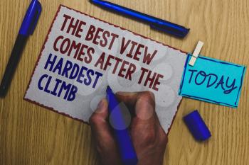 Conceptual hand writing showing The Best View Comes After The Hardest Climb. Business photo text reaching dreams takes effort Man holding marker paper clothespin express ideas wooden table