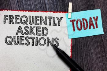 Writing note showing Frequently Asked Questions. Business photo showcasing inquries that been informed more than one time White page red borders marker clothespin reminder wooden background