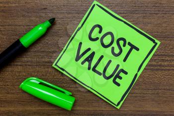 Conceptual hand writing showing Cost Value. Business photo showcasing The amount that usualy paid for a item you buy or hiring a person Green Paper Communicate ideas Marker Wooden background