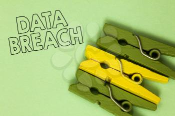 Text sign showing Data Breach. Conceptual photo security incident where sensitive protected information copied Three green yellow vintage clothespins clear background Holding things