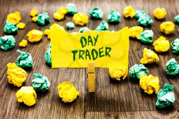 Writing note showing Day Trader. Business photo showcasing A person that buy and sell financial instrument within the day Clothespin holding yellow note paper crumpled papers several tries