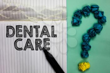 Conceptual hand writing showing Dental Care. Business photo text maintenance of healthy teeth or to keep it clean for future Notebook marker crumpled papers question mark on green background