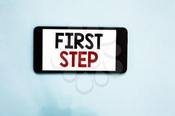 Text sign showing First Step. Conceptual photo Pertaining to the start of a certain process or beginning Cell phone white screen over light blue background text messages apps